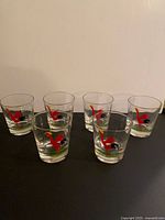 Six rooster-pattern cocktail glasses on surface