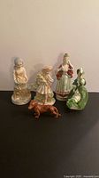 Group of five figurines on black surface