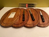 All items overview: four wooden boards, three loose Ginsu knives, two packaged knives