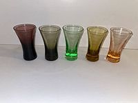 Five coloured etched liqueur glasses lined up