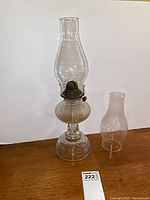 Full view of lamp with fitted chimney and spare chimney