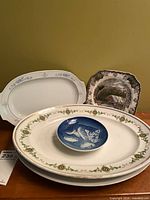 Stacked view of all four plates showing relative sizes and patterns