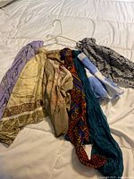 Group shot of all seven scarves draped on hanger