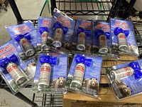 Ten new Frontiersman Bear Horns still sealed in packaging spread on a black wire shelf.