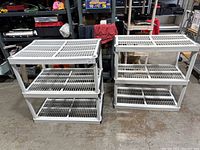 Both small plastic shelving units placed side by side showing size difference and three-tier design.