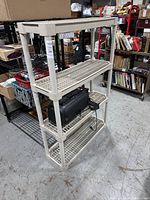 Side and angled views showing four-tier beige plastic shelving unit with grated shelves and cylindrical posts.