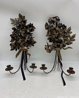 Pair of rusted patina Italian floral tole wall candelabras with three candle holders each, shown front view