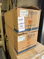 Pair of sealed cardboard boxes labeled CX-5 tail lamp, model KR11-51150 with MaxSold auction stickers