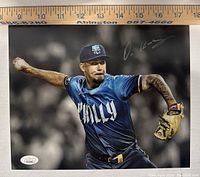 Full view of signed photo showing Orion Kerkering pitching in Phillies blue jersey, ruler on top for size reference.