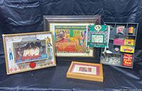 Full grouping of Stephen Millner mixed media art pieces displayed against black backdrop showing four distinct artworks including shadow box and framed prints