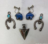 Full lot view showing two pairs of earrings and one pendant