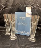 Four Marquis by Waterford Phillies pilsner glasses arranged around the box showing the full set and packaging.