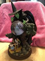 Photo showing complete Bradford Exchange Wizard of Oz statue featuring Wicked Witch of the West with crystal ball and characters below
