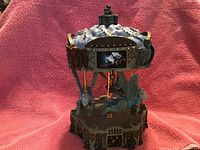 Photo of the San Francisco Music Box Wicked Witch Merry Go Round showing detailed carousel with characters and small embedded screen