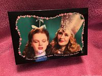 Photo of the music box showing Dorothy and Glenda the Good Witch with the text 'There's no place like home'