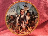Front view of the Wizard of Oz 50 Year Anniversary collector's plate from The Hamilton Collection showing full artwork and border design.