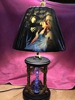 Full view of lamp showing printed shade and hourglass base