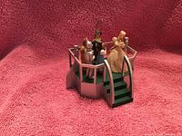 Image of Hallmark 2003 Christmas ornament titled Glinda Speaks with Wizard of Oz characters on a platform