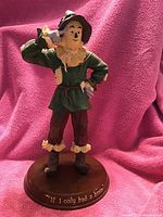 Photo of the 14-inch tall Scarecrow figurine from Westland, model #1891, standing on a wooden base inscribed with 'If I only had a brain.'