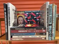 Front view of 13 photography books arranged vertically and horizontally showing titles and spines.