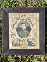 Full view of framed antique print showing the portrait of Louis Napoleon Bonaparte with decorative border and water stains