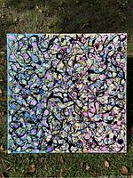 Full view of square abstract painting on canvas with colorful background and black swirling line pattern.