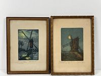 Two framed color etchings of windmills with moonlit backgrounds, showing vintage wooden frames and aged matting.