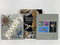 Photo of three hardcover jewelry reference books, front covers visible with jewelry images and titles.