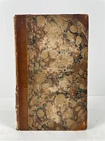 Spine and marbled cover of the half leather bound book showing wear and detached covers.