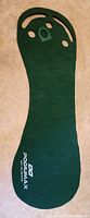 Full length of Podiumax golf putting mat showing shape with various hole cutouts for practice.