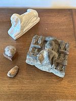 Overview of all four sculptures on wooden surface