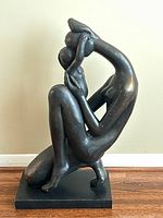 Front view of composite sculpture showing kneeling woman holding child
