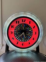 Front view illuminated neon red with spinning kaleidoscope center and ribbed clear bezel