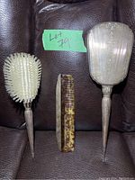 Full view of brush, comb, and hand mirror showing size and overall design of the vanity set.