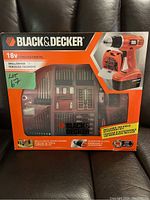 Front view of sealed Black & Decker 18V cordless drill kit box showing full accessory set and drill image.