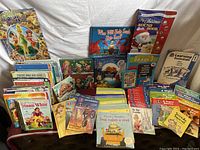 Overview of children's book collection displayed on a white fabric background, showing various titles and colorful covers