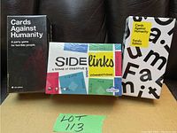 Photo of three sealed games: Cards Against Humanity original, Cards Against Humanity Family Edition, SideLinks game