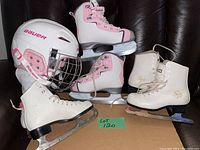 Photo showing three pairs of ice skates and Bauer hockey helmet all arranged clearly on a dark chair with lot label.