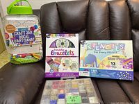 Photo showing the full set of kids craft items including the giant craft jar, friendship bracelets kit box, stencils kit box, and bead container.