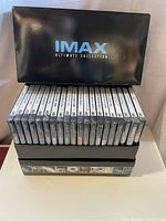 Front view of black IMAX Ultimate Collection box containing 20 DVDs arranged vertically, showing their spines.