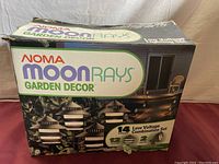 Box image showing Noma Moon Rays Garden Decor branding and photo of garden lights