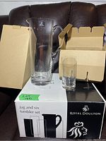 Photo of the Royal Doulton jug and one tumbler with box and protective cardboard inserts in background.
