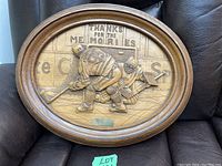 Full view of oval wooden plaque showing Wayne Gretzky hockey scene carved in relief with 'Thanks for the Memories' text in background.