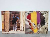 Front covers of two Bob Dylan LP albums: 'Street-Legal' and 'Dylan' side by side showing artwork and condition