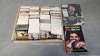 Photo of a box containing over 1500 assorted hockey cards organized in stacks, with visible cards showing hockey imagery.