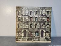 Front cover of Led Zeppelin self-titled album showing apartment building artwork on gatefold cover.