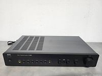 Angled front view of amplifier showing overall unit and control layout