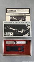 Photo of Shure Precision Stylus Force Gauge with original box and instruction manual visible