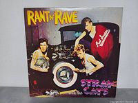 Front cover of Stray Cats Rant N Rave album showing band members and stylized text.