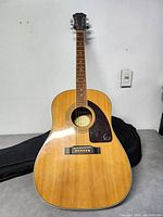 Front view of Epiphone guitar and gig bag on table